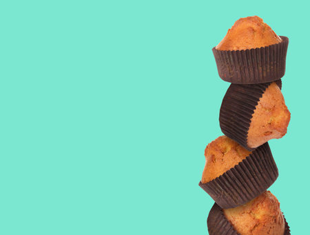 Stack of tasty muffins on turquoise background. Space for textの写真素材