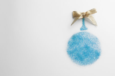 Christmas ball made of light blue glitter with bow on white background, top view. Space for textの写真素材