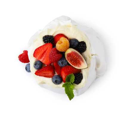 Pavlova cake (meringue dessert) with whipped cream, fresh berries, mint and fig isolated on white, top viewの写真素材