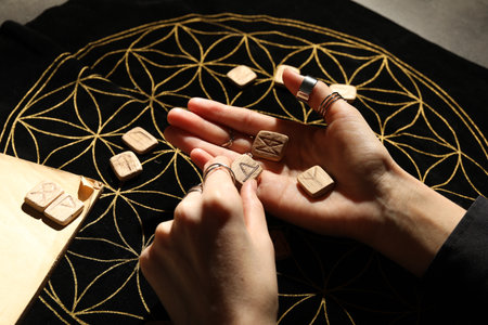 Woman with wooden runes at divination mat, closeupの写真素材
