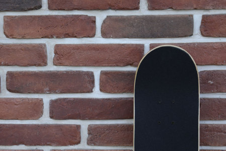 One skateboard near brick wall outdoors, space for textの写真素材