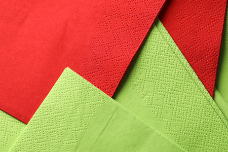 Red and green tissues as background, top viewの写真素材