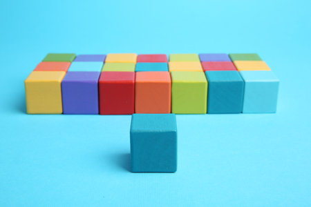 Many colorful cubes on light blue background