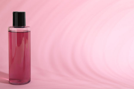 Shampoo in bottle on pink background, space for textの写真素材