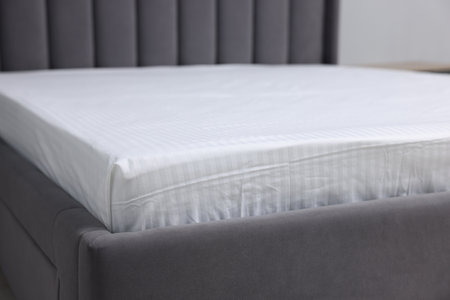 Comfortable bed with clean lines at home, closeup