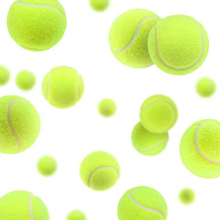 Many bright tennis balls in the air on white backgroundの写真素材