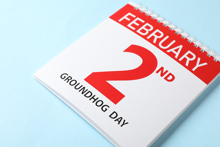 Calendar with date February 2nd on light blue background, closeup. Groundhog day