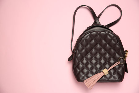 Backpack with leather keychain on pink background, top view. Space for textの写真素材