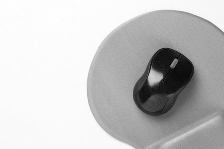 Computer mouse and mousepad on white table, top view. Space for textの写真素材