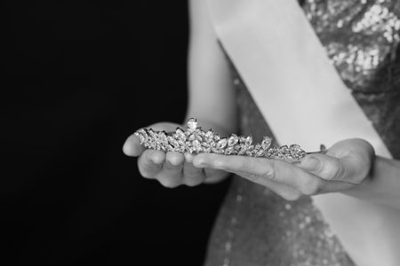 Woman holding luxury tiara, closeup. Black-and-white photoの写真素材