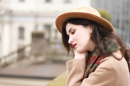 Beautiful woman in hat and coat outdoors, space for textの写真素材