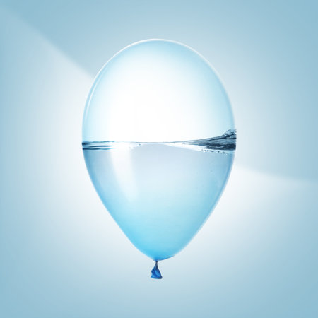 Balloon with water inside on light blue backgroundの写真素材