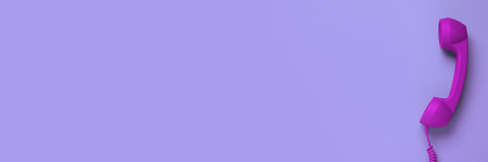 Purple corded telephone handset on violet background, top view. Banner design with space for text