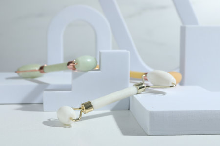 Stylish presentation of face rollers on light gray background, closeupの写真素材