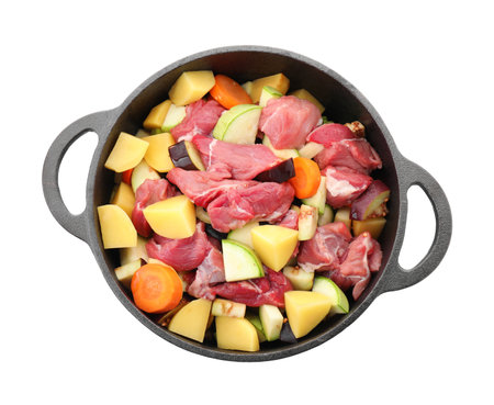 Cooking stew Uncooked meat and vegetables in pot isolated on white, top viewの写真素材