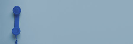 Blue corded telephone handset on gray background, top view. Banner design with space for text
