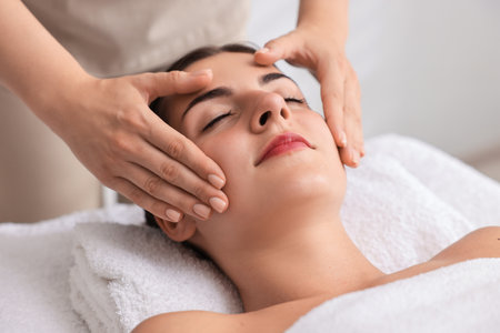 Attractive woman enjoying face massage, closeup. Beauty procedureの写真素材