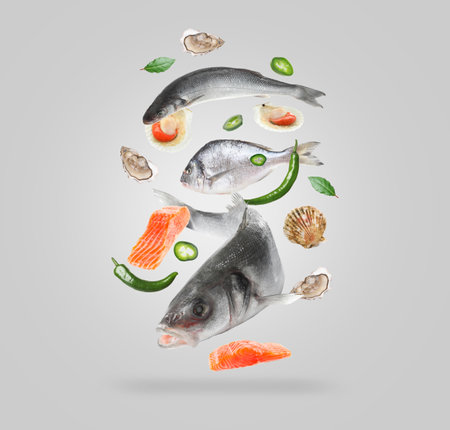 Different sea food in air on light gray backgroundの写真素材