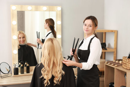 Hair cutting. Professional hairdresser working with client in salonの写真素材