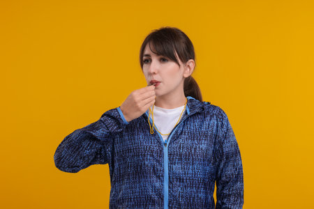 Young woman blowing whistle