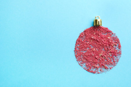 Christmas ball made with blush on light blue background, top view. Space for textの写真素材