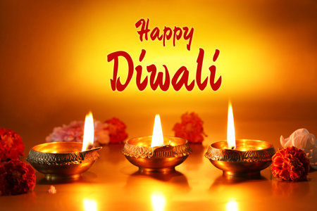 Happy Diwali greeting card, Hindu festival of lights. Diya lamps and beautiful flowers on golden backgroundの写真素材