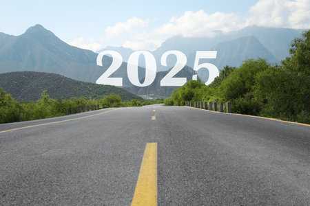 Asphalt road leading to 2025 sign. Concept of new year, fresh beginningの写真素材