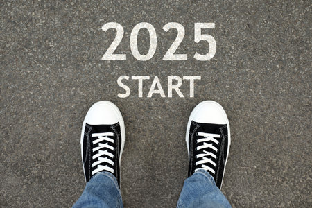 Man standing near sign 2025 Start on asphalt, top view. Concept of new year, fresh beginning
