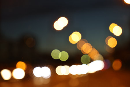 Blurred view of city street with lights at night