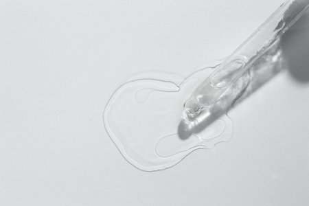 Cosmetic oil and pipette on light gray background, top viewの写真素材