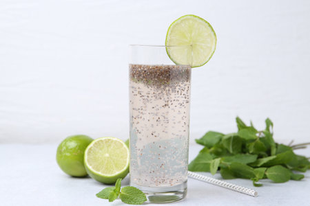 Glass of drink with chia seeds and lime on white table, closeupの写真素材