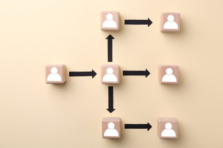 Human resource. Scheme of wooden cubes with human icons on beige background, top view
