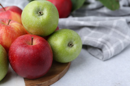 Fresh ripe apples on light gray table, closeupの写真素材