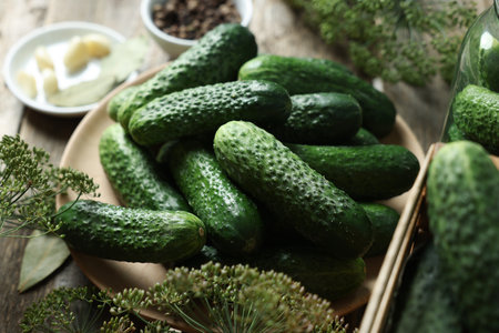 Fresh cucumbers and dill on wooden table, closeup. Preparation for picklingの写真素材