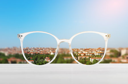 Glasses against cityscape. View through lenses more clear. Vision correctionの写真素材