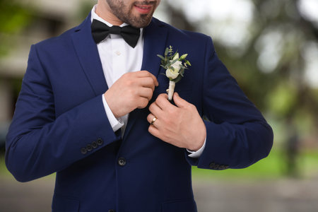 Formal attire with boutonniere outdoors, closeup. Wedding accessoryの写真素材