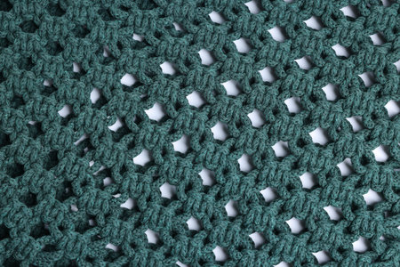 Handmade macrame shopping bag as background, closeup