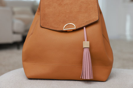 Backpack with pink leather keychain on soft surface indoors, closeupの写真素材