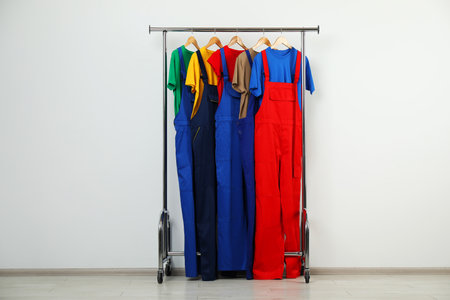 Workers' uniforms on clothing rack near gray wall indoorsの写真素材