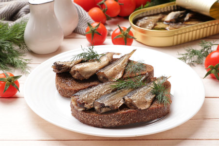 Delicious sandwiches with sprats and dill served on white wooden table, closeupの写真素材