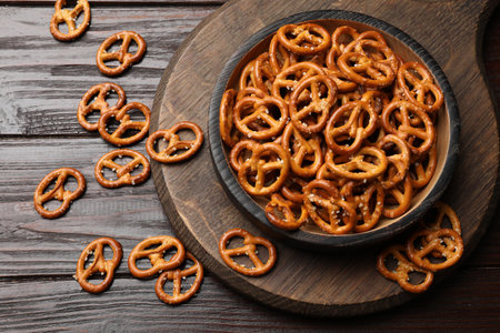 Tasty pretzel crackers on wooden table, top viewの写真素材