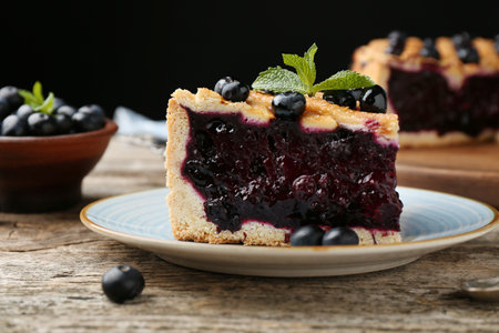 Slice of homemade blueberry pie on wooden table, closeupの写真素材