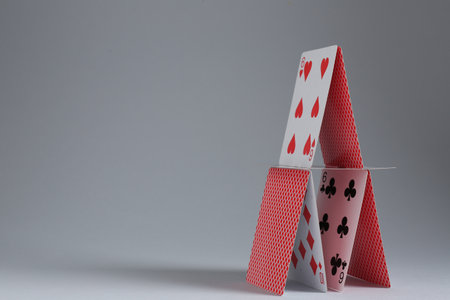 House of playing cards on light gray background. Space for textの写真素材