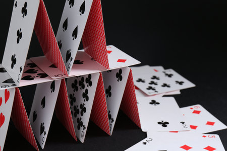 House of playing cards on black background, space for textの写真素材