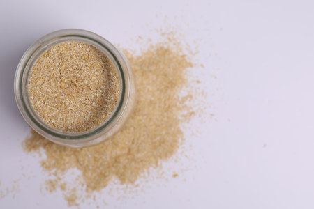 Oat bran in glass jar on white background, top viewの写真素材
