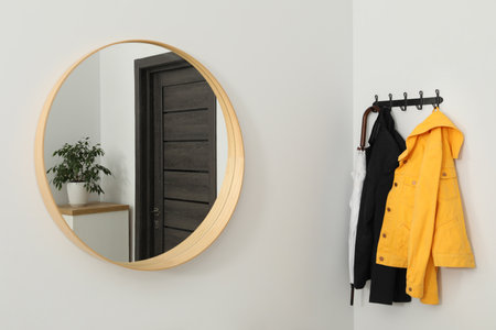 Mirror and rack with clothes in hallway. Interior designの写真素材