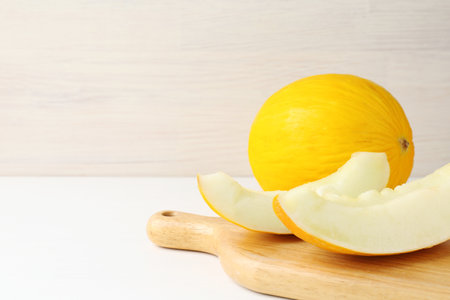 Fresh ripe melons on white table.
