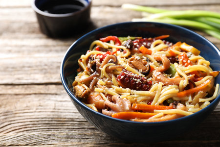 Stir-fry noodles with sea food and vegetables on wooden table, closeupの写真素材