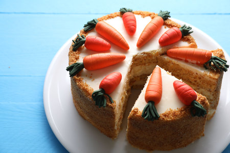 Plate with carrot cake on blue wooden table, closeupの写真素材