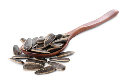 Sunflower seeds in wooden spoon isolated on whiteの写真素材